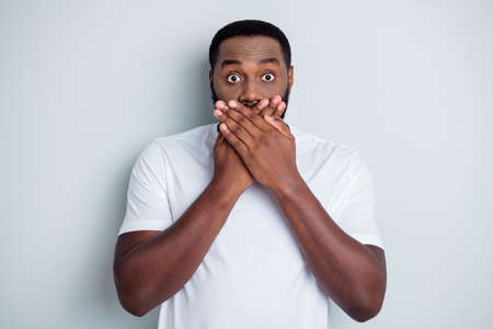 Photo of helpless dark skin african american guy unfairly society shut up black race citizens arms on mouth threatening danger afraid police lawlessness isolated grey color backgroundの写真素材
