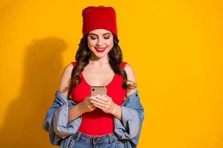Portrait of positive cheerful trend youngster millennial girl use smartphone type read share social...