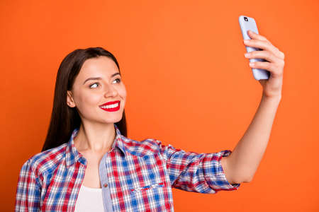 Positive cute sweet girl enjoy spring time journey make selfie on smartphone video call for her blog...
