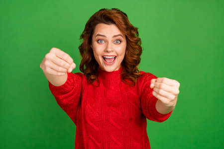Portrait of energetic positive cheerful redhead woman hold hands imagine she drive fast car wear good look knitted sweater isolated over shine color backgroundの写真素材