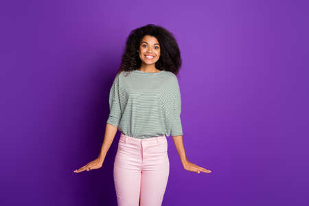 Portrait of charming girlish cheerful afro american girl have holidays feel candid good look wear casual style outfit isolated over purple color backgroundの写真素材