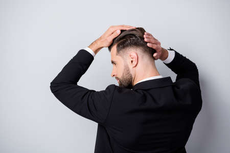 Back rear profile side photo of serious handsome worker man touch silky hair after haircare barber shop treatment partnership meeting wear black blazer isolated grey color backgroundの写真素材
