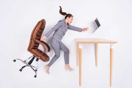 Top above high angle view full size profile side photo worried agent girl sit armchair impressed laptop fly wind blow try catch flat lay wear high heels isolated white color backgroundの写真素材