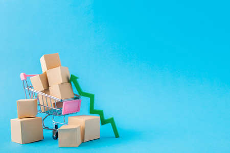 Picture of shopping cart carrying large parcels arrow going up developing, export sales management...