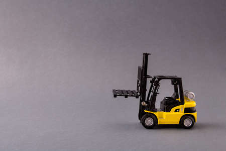 Photo of professional electric loader vehicle deliver service pallet move store mall market supply isolated over dark pastel grey color backgroundの写真素材