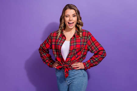 Portrait of her she nice attractive lovely lovable cheerful cheery girl in checked shirt winking having fun isolated over bright vivid shine vibrant lilac violet purple color backgroundの写真素材