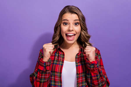 Close-up portrait of her she nice attractive lovely lucky overjoyed cheerful cheery girl in checked shirt celebrating isolated over bright vivid shine vibrant lilac violet purple color backgroundの写真素材