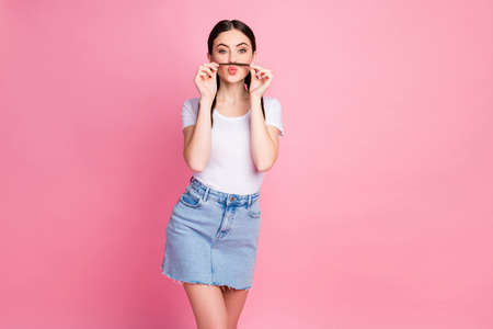 Portrait of her she nice-looking attractive lovely winsome girlish funny cheery girl making fake mustache having fun fooling isolated over pink pastel color backgroundの写真素材