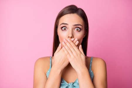 Close-up portrait of her she nice-looking attractive lovely winsome pretty stunned girl closing mouth dont speak oops isolated over pink pastel color backgroundの写真素材