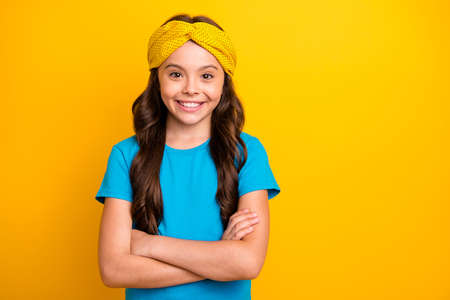 Portrait of positive cheerful kid girl future entrepreneur worker cross hands feel independent wear good look outfit isolated over bright color backgroundの写真素材