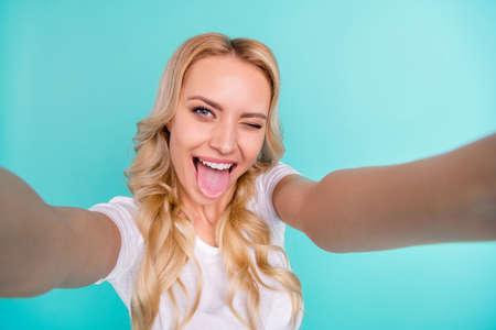 Close up photo of positive cheerful girl enjoy summer weekend holiday make selfie show tongue out...