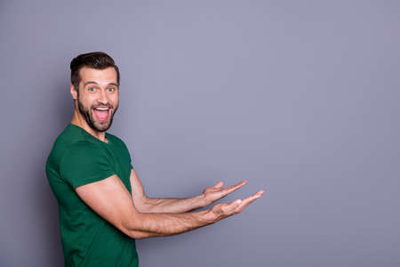 Profile photo of attractive amazed handsome guy good mood raise arms side empty space showing...