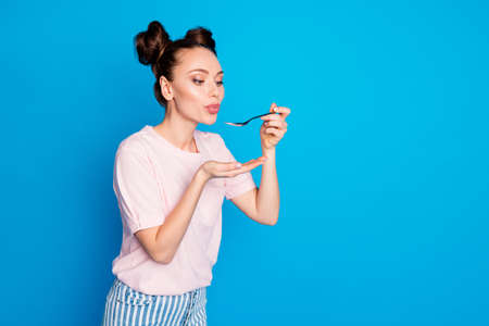 Photo of pretty lovely lady two funny buns blowing spoon hot soup meal cooking tasty meal overjoyed...