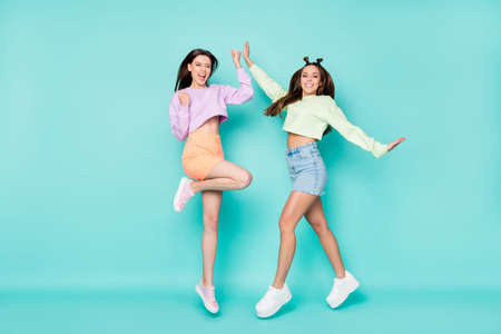 Full size photo of two pretty crazy lady sisters jump high up youth clothes rejoicing students party...