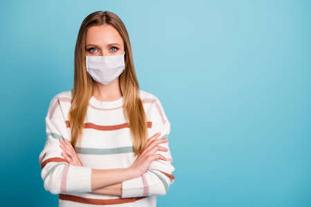Close-up portrait of nice girl wearing safety cotton reusable mask folded arms mers cov influenza...
