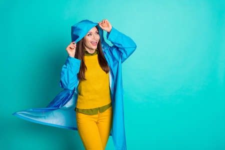 Photo of attractive pretty funny lady cheerful mood rainy weather, street walk hood head protect...