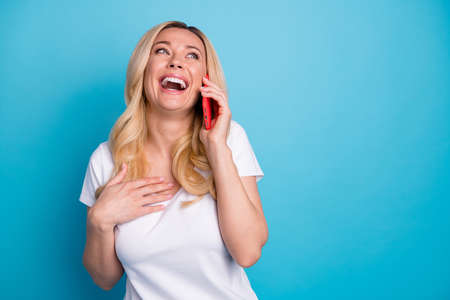 Photo of attractive amazed wavy lady hold telephone hands listen friend talking laughing out loud...