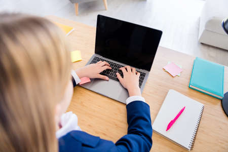 Back rear behind cropped view photo of small blonde hair school girl laptop notebook video call for...