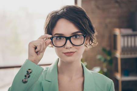 Closeup photo of beautiful business lady arm on eyesight specs self-confident person chief insurance agent home remote distance work wear blazer stand modern interior home office indoorsの写真素材
