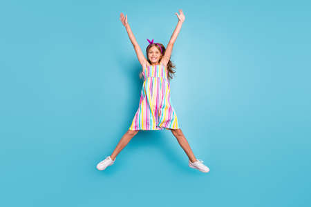 Full length body size view of her she nice attractive lovely pretty glad cheerful cheery girl jumping enjoying holiday vacation having fun isolated on bright vivid shine vibrant blue color backgroundの写真素材