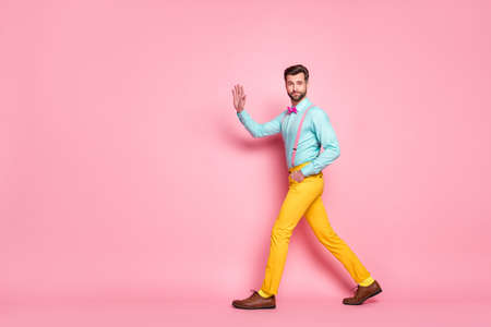 Full length profile photo of handsome guy trend look walk meeting red carpet celebrity waving hand...
