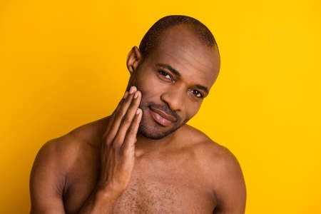 Close up photo of serious macho afro american guy look mirror enjoy shave procedure treatment isolated over bright color backgroundの写真素材