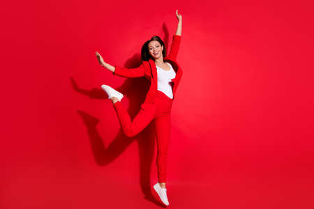 Full length photo of attractive funny lady successful worker having fun jumping high up good mood...
