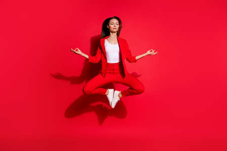Full length photo of attractive lady worker jumping high up meditating eyes closed work pause...