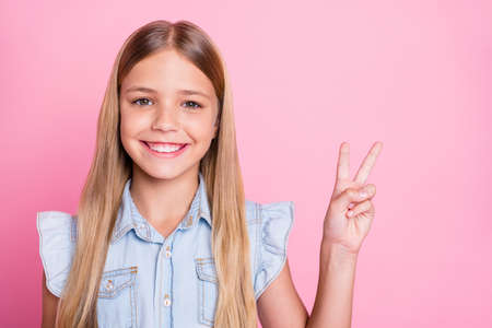 Portrait of cute nice girl kid enjoy spring weekend holiday make v-sign wear good look outfit...