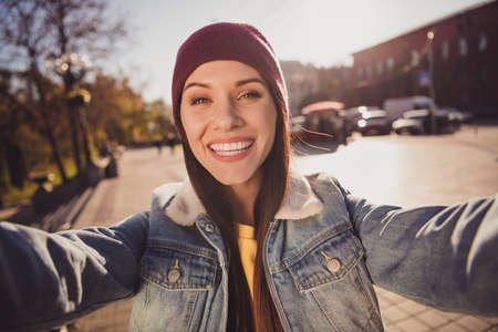 Self-portrait of her she nice attractive pretty lovely cheerful cheery brown-haired girl spending free time strolling alone fresh air traveling abroad October streetstyleの写真素材