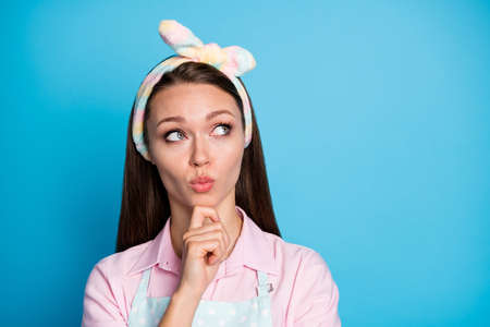Portrait of minded interested wife girl touch chin fingers look copyspace think thoughts decide choose decision choice isolated over blue color backgroundの写真素材