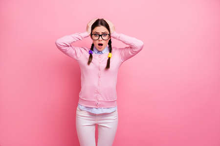 Portrait of her she attractive lovely pretty worried depressed overwhelmed brown-haired girl nerd terrible news information deadline reaction isolated over pink pastel color backgroundの写真素材