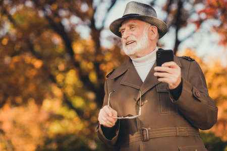 Photo of aged funny white hair grandpa hold specs telephone see grandchildren family take off specs...