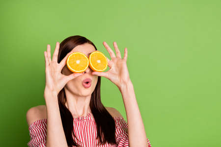 Close up photo of cute pretty playful student girl hold two oranges spectacles shocked imagine...