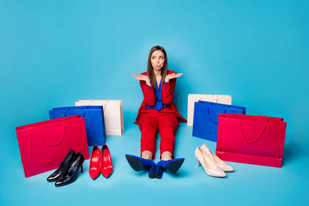 Full length photo of upset lady successful worker sit offended floor near shoes shopping bags...