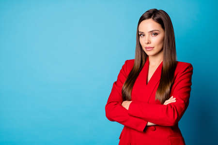 Close-up portrait of her she nice-looking attractive lovely charming clever smart serious lady top manager economist folded arms isolated over bright vivid shine vibrant blue color backgroundの写真素材