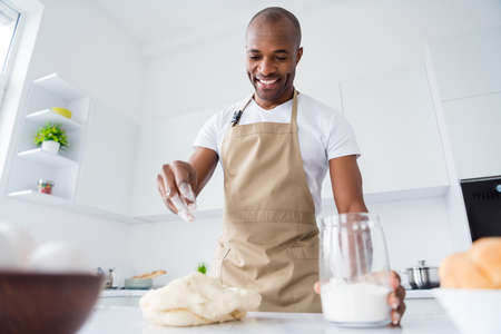 Portrait of his he nice attractive confident cheerful guy confectioner preparing fresh bread pizza...