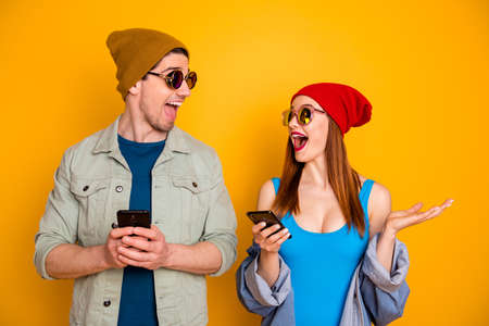 Photo of excited crazy two people students man guy use smart blogging social network wear cap shirt...