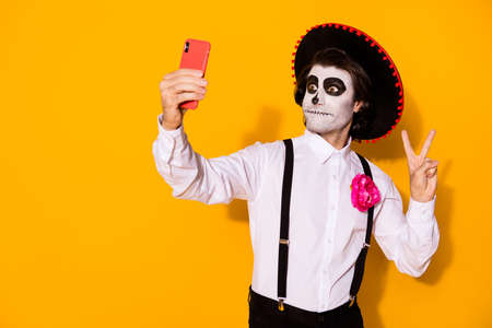 Portrait of his he nice handsome painted spooky guy caballero taking making selfie calavera carnival...