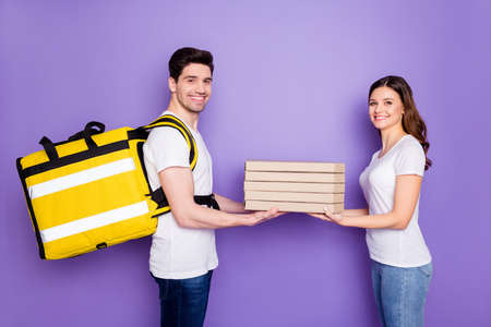 Portrait of positive courier man deliver pile stack pizza girl she order on home corona virus quarantine wear white t-shirt denim jeans isolated over purple color backgroundの写真素材