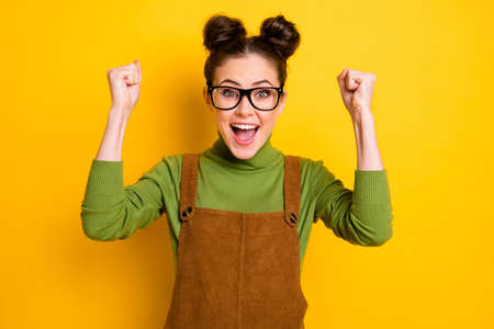 Photo of ecstatic crazy girl high school geek celebrate good grades exam pass raise fists scream...