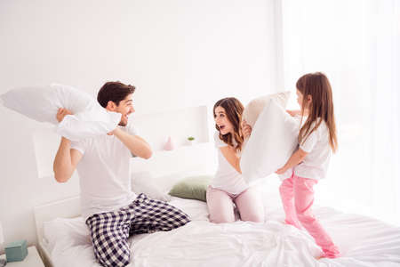 Photo of happy family mommy daddy daughter sheets good mood having fun spend together quarantine...