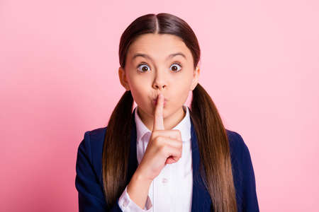 Close-up portrait of her she nice attractive wondered brown-haired girl showing shh sign quiet...