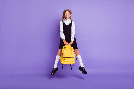 Full length body size view of her she nice attractive cheerful cheery crazy small little schoolkid jumping having fun isolated bright vivid shine vibrant lilac violet purple color backgroundの写真素材