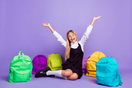 Portrait of her she nice attractive cheerful cheery glad long-haired girl sitting among colorful bags having fun isolated bright vivid shine vibrant lilac violet purple color backgroundの写真素材