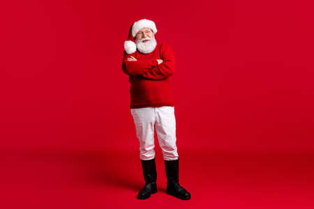 Full body photo of old man in santa claus headwear cross hands enjoy jolly holly magic miracle event wear jumper trousers boots isolated over bright shine color backgroundの写真素材