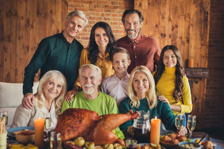 Portrait of full family eight members thanks giving meeting sit table greeting dinner photographing...