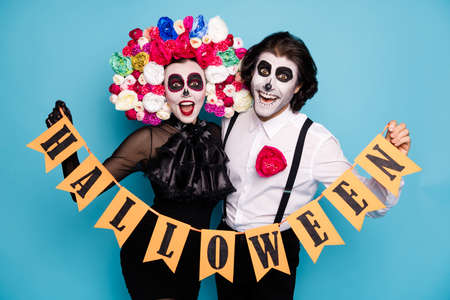 Photo of cute frightening couple man lady cuddle hold flagged ribbon costume autumn theme event wear...