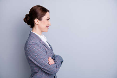 Profile photo of attractive confident business lady arms crossed good mood experienced teacher occupation look empty space wear plaid suit jacket white shirt isolated grey color backgroundの写真素材