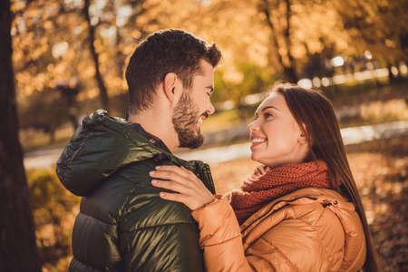 Photo of affectionate trust couple girl look into boyfriends face in fall october forest park wear...
